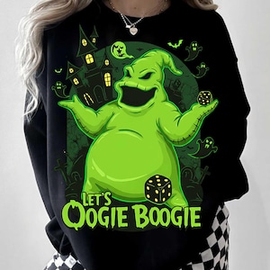May include: Black sweatshirt featuring a green Oogie Boogie character with dice and a haunted house background. The text "Let's Oogie Boogie" is in green. The design has a Halloween theme.