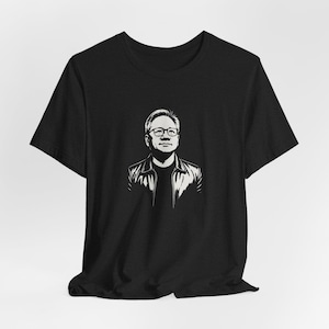 May include: Black t-shirt featuring a black and white graphic portrait of a man wearing glasses and a leather jacket. The design is a stylized illustration, likely for fans of the subject.
