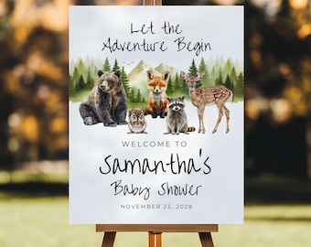 May include: A wooden easel displays a sign with the text "Let the Adventure Begin." The sign features illustrations of forest animals, including a bear, fox, owl, raccoon, and deer. The sign reads "Welcome to Samantha's Baby Shower" and the date.