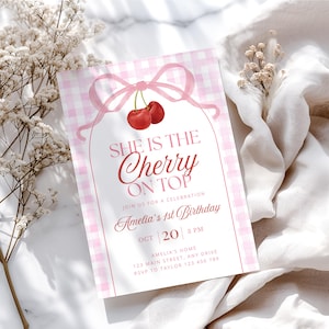 May include: A pink gingham-patterned invitation with the text "She is the Cherry on Top" and a watercolor illustration of cherries. The invitation is for Amelia's 1st birthday, with the date and time displayed. The design includes a bow and decorative elements.