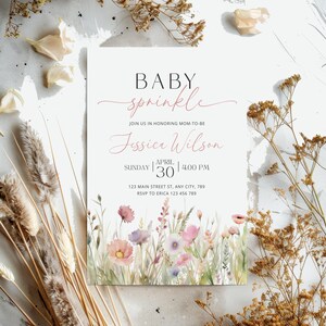 May include: A baby sprinkle invitation with a watercolor floral design. The invitation reads "BABY sprinkle" and "Jessica Wilson" with the date "SUNDAY | APRIL 30 | 4:00 PM". The address is "123 MAIN STREET ST, ANY CITY, 789" and the RSVP information is "RSVP TO ERICA 123 456 789".