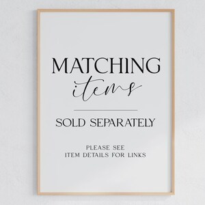 May include: A framed print with the words "MATCHING items" in a decorative font above the words "SOLD SEPARATELY". Below is the text "PLEASE SEE ITEM DETAILS FOR LINKS". The frame is a light wood color.