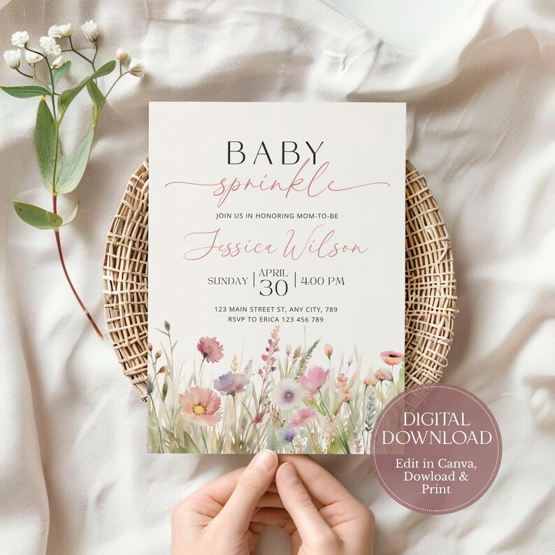 May include: A digital download for a baby sprinkle invitation. The invitation features a watercolor illustration of pink and purple wildflowers with green stems and leaves. The text on the invitation reads "BABY sprinkle JOIN US IN HONORING MOM-TO-BE Jessica Wilson SUNDAY APRIL 30 | 4:00 PM 123 MAIN STREET ST, ANY CITY, 789 RSVP TO ERICA 123 456 789". The text "DIGITAL DOWNLOAD Edit in Canva, Download & Print" is also included.