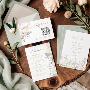 May include: A wedding stationery set featuring a white invitation, RSVP card with a QR code, and details card, all decorated with watercolour floral illustrations. The set includes sage green envelopes and is displayed with sprigs of flowers.