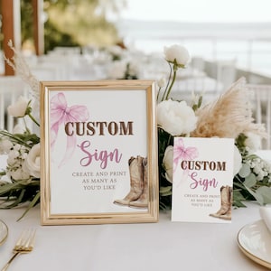 May include: A framed custom sign with a gold border, featuring a pink bow and cowboy boots illustration. The sign reads "CUSTOM Sign" and "CREATE AND PRINT AS MANY AS YOU'D LIKE". A smaller matching sign is also present.