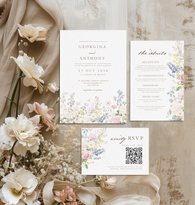 May include: A wedding invitation suite featuring a main card, a details card, and an RSVP card with a QR code. Each white card displays floral illustrations in pastel pink, blue, and yellow, with dark brown serif and script text throughout.