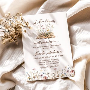 May include: A baby shower invitation with the text "A New Chapter will soon begin..." features an open book with floral illustrations. The invitation includes the name Nicole Anderson, date, time, and address.