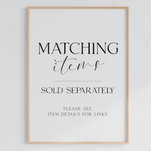 May include: A vertical rectangular sign in a light wood frame with black text on a white background. The text reads: MATCHING items SOLD SEPARATELY PLEASE SEE ITEM DETAILS FOR LINKS. The sign is centred and features a mix of serif and script fonts.