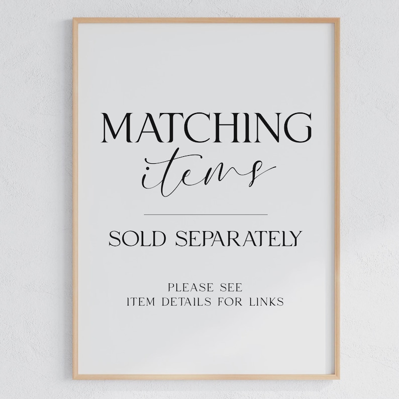 May include: A vertical rectangular sign in a light wood frame with black text on a white background. The text reads: MATCHING items SOLD SEPARATELY PLEASE SEE ITEM DETAILS FOR LINKS. The sign is centred and features a mix of serif and script fonts.