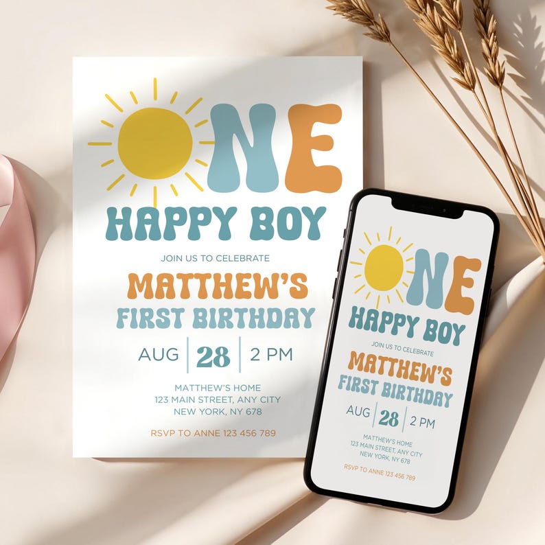 May include: A birthday invitation and a smartphone display the same design. The design features a yellow sun, the words "ONE HAPPY BOY," and details for Matthew's first birthday on August 28th at 2 PM. The invitation is white with a retro font.