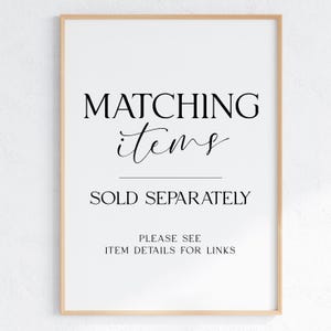 May include: A framed print with the words "MATCHING items" in a decorative font above the words "SOLD SEPARATELY". Below, it reads "PLEASE SEE ITEM DETAILS FOR LINKS". The frame is a light wood color.
