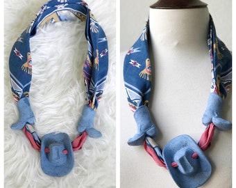 Vintage kitschy blue western bandana with clay boots and hat