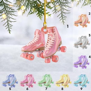 May include: Pink roller skate ornament with white laces and pink wheels. The word "Name" is printed on the side of one skate. Additional colour options include peach, silver, purple, blue, green, yellow, and teal roller skates.