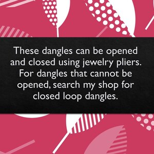 May include: Black text on a dark gray background with a pink and white geometric pattern behind it. The text reads: "These dangles can be opened and closed using jewelry pliers. For dangles that cannot be opened, search my shop for closed loop dangles."