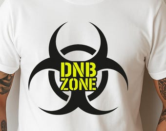 May include: White t-shirt featuring a black biohazard symbol with the text "DNB ZONE" in yellow. The design is centered on the chest. The shirt is short-sleeved and appears to be made of cotton.