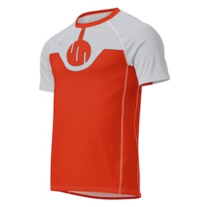 May include: A short-sleeved, athletic shirt in a vibrant red and white color scheme. The shirt features a unique design on the chest, with a white upper section and a red lower section. The design includes a stylized emblem in the center.