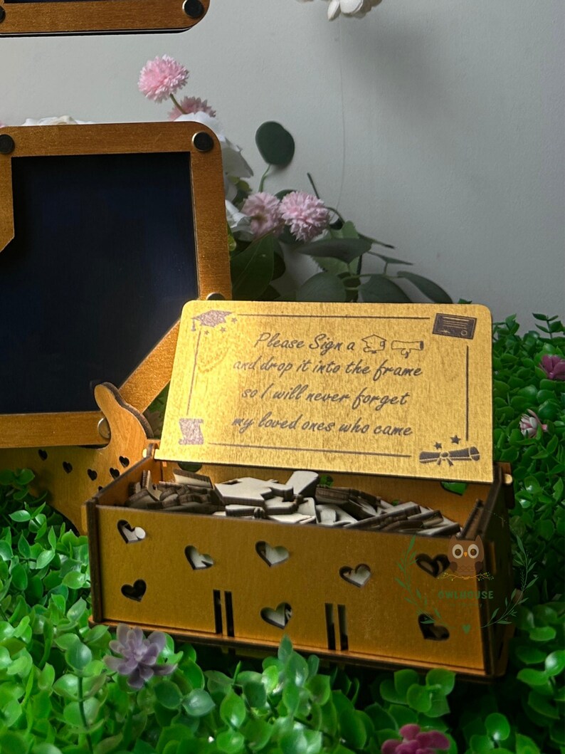 Custom grad guestbook drop box displayed with cap and diploma decor details