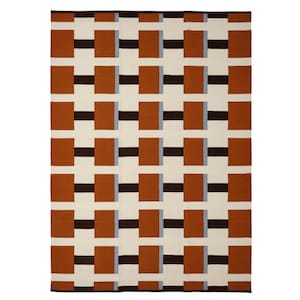 May include: A rectangular woven rug featuring a repeating geometric pattern of large terracotta orange rectangles, dark brown horizontal bars, and thin light blue vertical stripes set against a cream-colored background with a dark brown border.