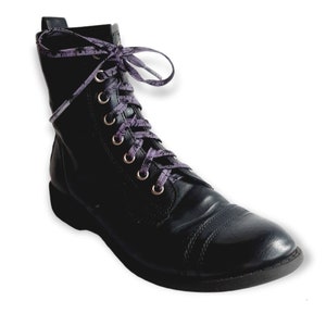 May include: Black leather lace-up boots with purple and white patterned shoelaces.