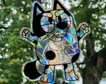 May include: A black and white cartoon dog sticker with a holographic iridescent finish. The dog has a grumpy expression and is standing on all fours.