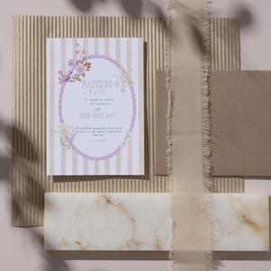 Può includere: Un cartoncino rettangolare per invito al battesimo con strisce verticali beige e bianche, una cornice ovale smerlata viola e illustrazioni floreali. Il testo recita: BAPTISM ELIS, Is ready to receive the sacrament ON 29TH APRIL 2027.