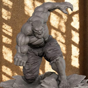 May include: A grey 3D-printed sculpture of the Hulk in a dynamic pose, with ripped shorts and an angry expression. The figure is on a rocky base. The text "EAGLE 3D STORE" is at the bottom.