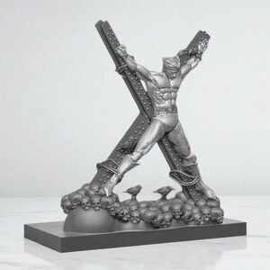 May include: A silver-colored sculpture of a superhero figure bound to a large X-shaped structure. The base features skulls and small bird figures. The sculpture is detailed and stands on a rectangular base.