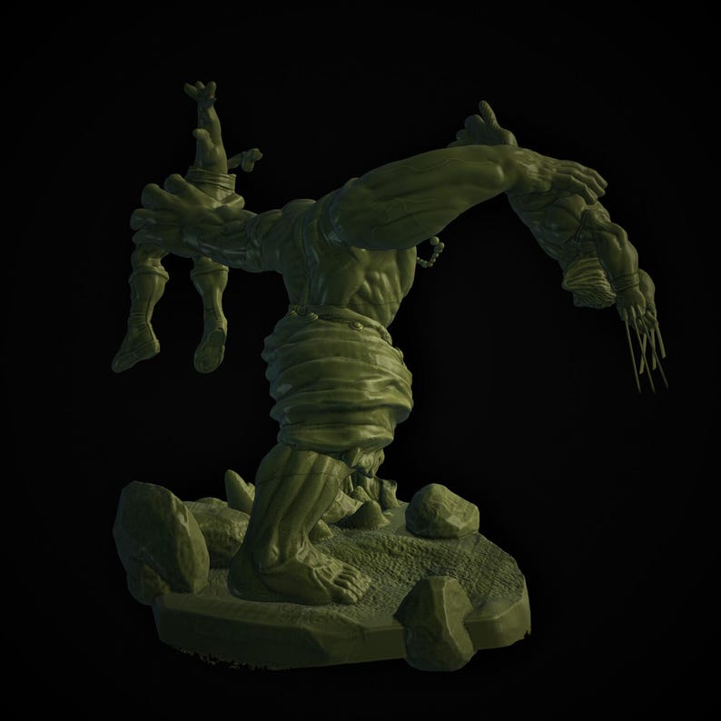 May include: A green figurine of a muscular monster holding a smaller figure. The monster is posed on a rocky base with several stones. The monster's arm is outstretched, and it has a menacing expression.