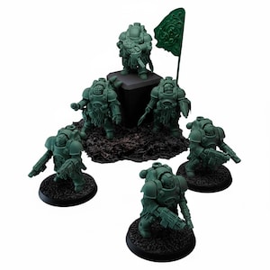 May include: A collection of six green miniature figurines of armored soldiers, some holding weapons, on black circular bases. One figure stands atop a dark platform, and a green flag is positioned nearby. The figures are detailed and appear to be part of a tabletop game.