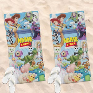 May include: Two rectangular beach towels featuring a colorful Toy Story character collage with Woody, Buzz Lightyear, Jessie, Rex, and other figures. The center displays the text NAME STORY in yellow and red. Each towel is paired with white flip-flops.