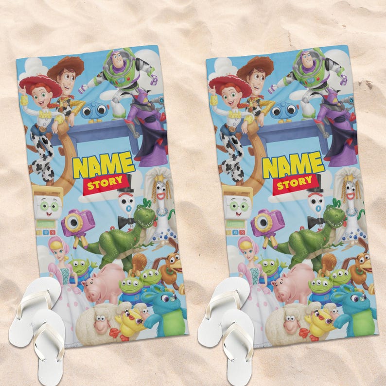 May include: Two rectangular beach towels featuring a colorful Toy Story character collage with Woody, Buzz Lightyear, Jessie, Rex, and other figures. The center displays the text NAME STORY in yellow and red. Each towel is paired with white flip-flops.