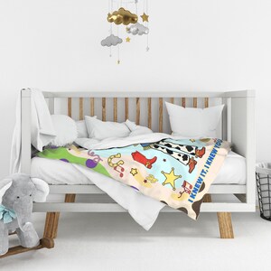 May include: A soft blanket featuring a colorful western-themed print with cow print patterns, red cowboy boots, yellow stars, horseshoes, and musical notes. The text "I KNEW IT, I KNEW YOU" is printed along the edge of the fabric in blue letters.