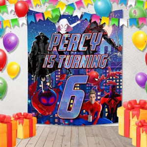 May include: A rectangular birthday backdrop featuring various Spider-Man characters, the text PERCY IS TURNING 6, and a city skyline. The scene is framed by colorful balloons and bunting, with two yellow gift boxes with red ribbons in the foreground.