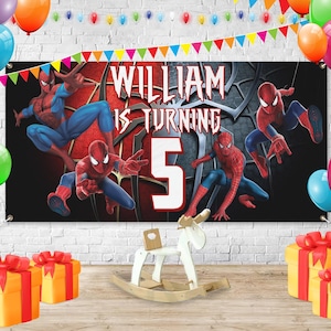 May include: A birthday banner with Spider-Man graphics and the text "WILLIAM IS TURNING 5". The banner is black with red and blue details, and is decorated with balloons and colourful gift boxes.