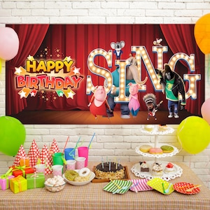 May include: A birthday party scene with a banner that says "Happy Birthday" and "Sing" with cartoon characters. Balloons in various colors and a table with treats and gifts complete the festive setting.