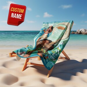 May include: A wooden beach chair with a custom name tag. The chair has a blue and green patterned fabric with a graphic of a woman and a man. The chair is on a sandy beach with the ocean in the background.