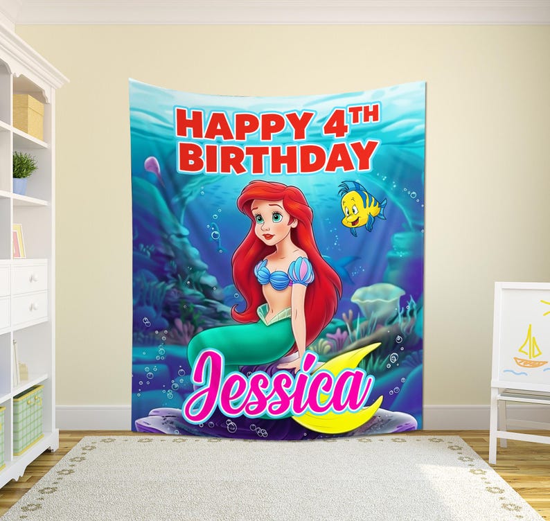 May include: A vibrant birthday banner with a mermaid illustration. The banner displays the text "Happy 4th Birthday Jessica" in pink and blue, with a cartoon fish. The mermaid has red hair and a green tail.