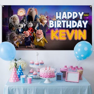 May include: A birthday party scene with a banner that reads "Happy Birthday Kevin" and features animated characters. The table is set with a cake, cupcakes, party hats, balloons, and other decorations. A blue tablecloth covers the table.