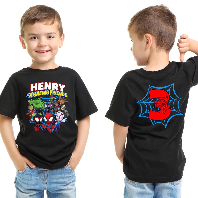 May include: A black short-sleeve t-shirt featuring a graphic on the front with the text "HENRY and the AMAZING FRIENDS" above a group of superhero characters. The back of the shirt displays a large red number 3 centered within a blue spiderweb.