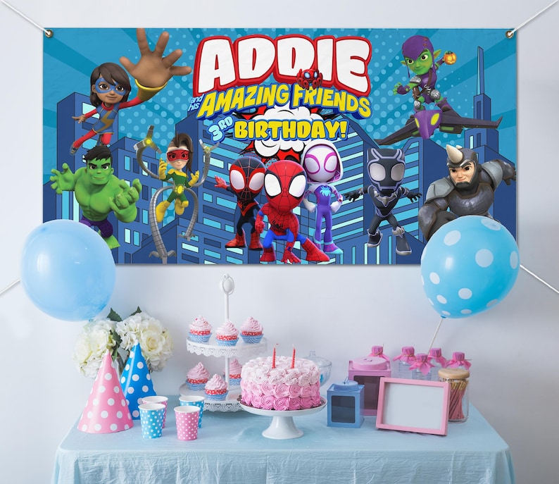 May include: A birthday party scene with a banner featuring superhero characters and the text "Addie and her Amazing Friends 3rd Birthday!" A pink and white cake, cupcakes, and balloons complete the festive decor.