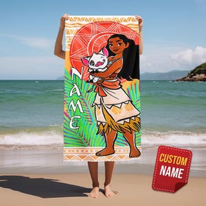 May include: A beach towel featuring a colorful illustration of a cartoon character holding a pig. The towel has a red and orange sun design, green palm leaves, and the word "NAME" in vertical text. A red sticker with "CUSTOM NAME" is in the bottom right.