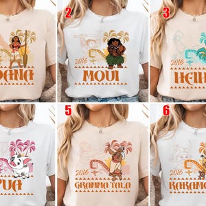 May include: A collection of six short-sleeved t-shirts in white and beige, each featuring a graphic print of a character from the 2016 film Moana, including Moana, Maui, Heihei, Pua, Gramma Tala, and Kakamora, with the year 2016 and character names.