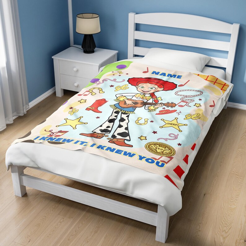 May include: A soft blanket featuring a cartoon cowgirl with red hair playing a guitar, surrounded by western icons like cowboy boots, sheriff stars, and horseshoes. The text NAME and I KNEW IT, I KNEW YOU are printed in blue on the light background.