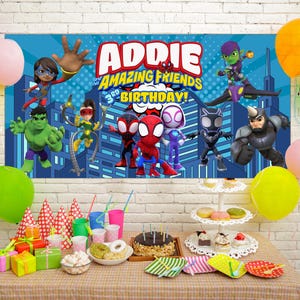 May include: A birthday party scene with a banner featuring superhero characters and the text "ADDIE'S AMAZING FRIENDS 3rd BIRTHDAY!". Colorful balloons, gifts, a cake, and party supplies are arranged on a table.
