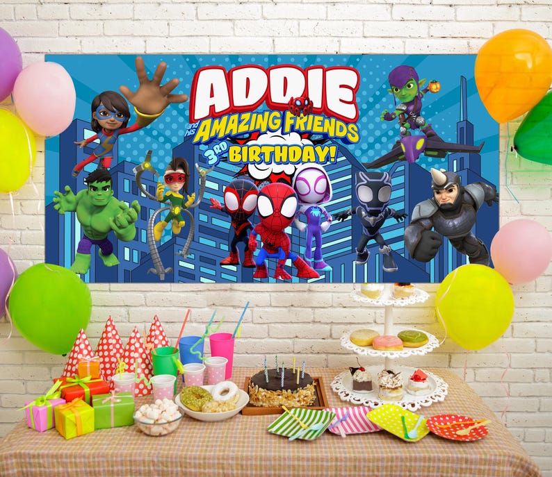 May include: A birthday party scene with a banner featuring superhero characters and the text "ADDIE'S AMAZING FRIENDS 3rd BIRTHDAY!". Colorful balloons, gifts, a cake, and party supplies are arranged on a table.