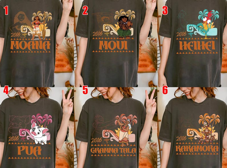 May include: A charcoal gray t-shirt featuring a graphic print of a Moana character, the year 2016, palm trees, and a decorative border. The design includes the character name in bold orange letters at the bottom, with six variations shown.