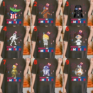 May include: A collection of dark gray t-shirts featuring various Star Wars characters and Baby Yoda, each adorned with patriotic Fourth of July designs. The shirts display the text "FOURTH OF JULY AMERICA" in red, white, and blue.