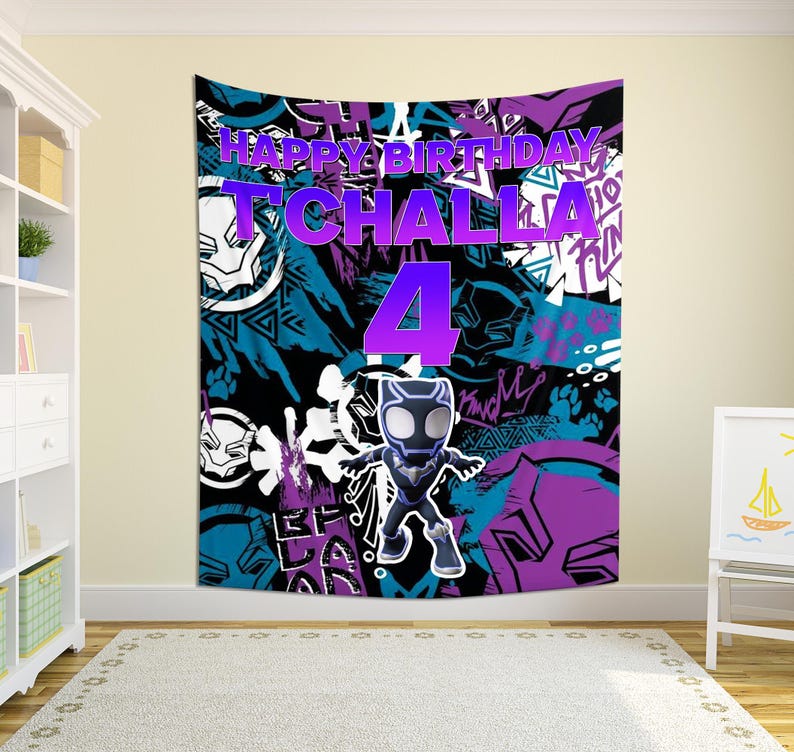 May include: A large wall tapestry with a colourful design featuring the text "HAPPY BIRTHDAY T'CHALLA 4". The tapestry has a black, blue, and purple background with a cartoon figure of Black Panther.