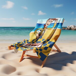 May include: A beach towel featuring a graphic of the character Woody from Toy Story, who is wearing a yellow shirt and brown hat. The towel has a blue and yellow checkered pattern at the bottom with the name Woody printed in a brown rectangular border.