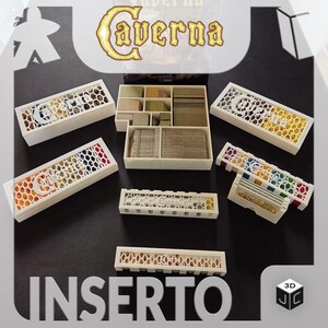 May include: White 3D printed game organiser insert for the board game Caverna. The insert has multiple compartments for storing game components, including a large compartment for the game board.